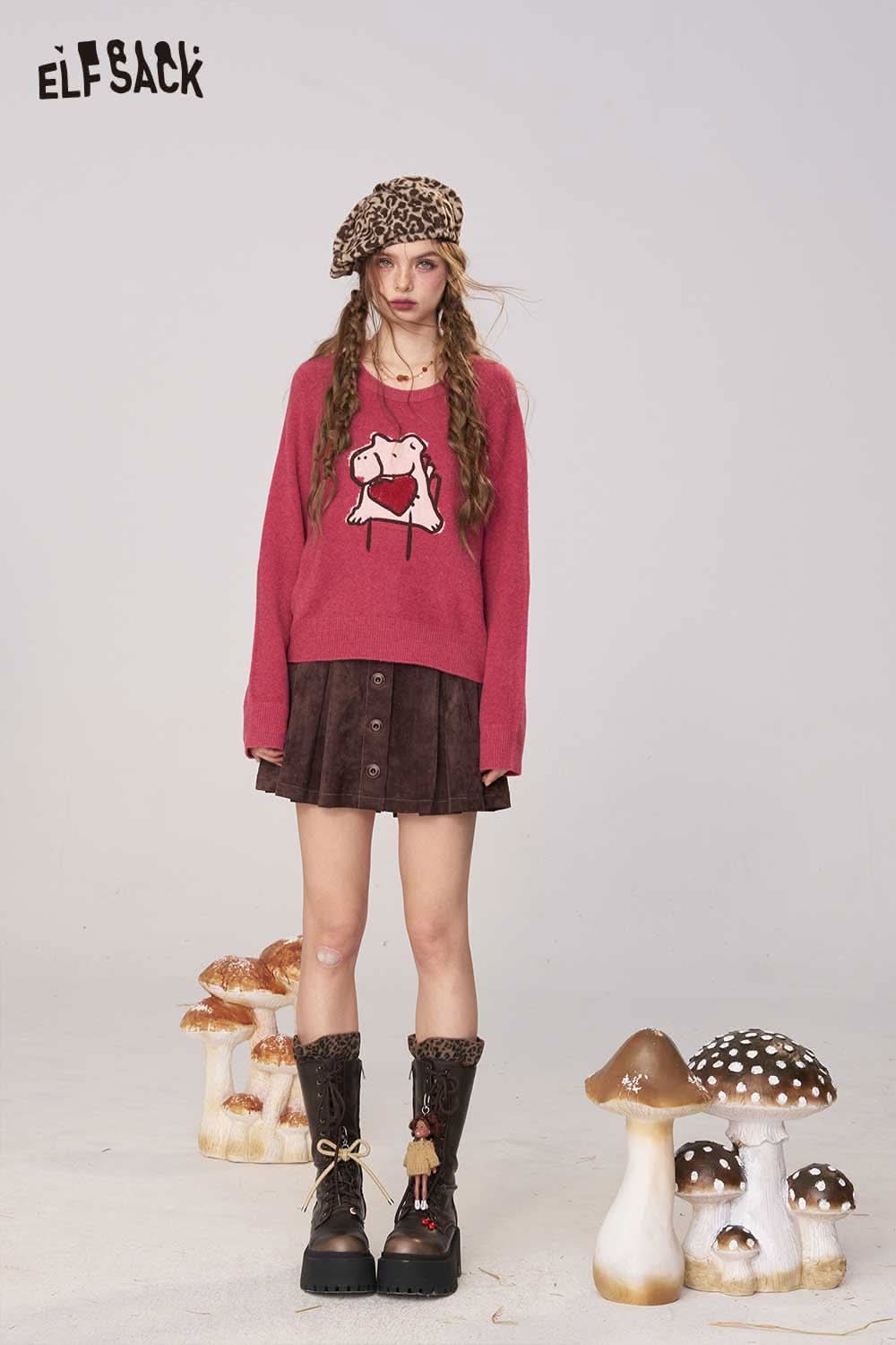 ELFSACK cartoon embroidery sweater in pink with playful design, styled with a brown skirt and knee-high boots