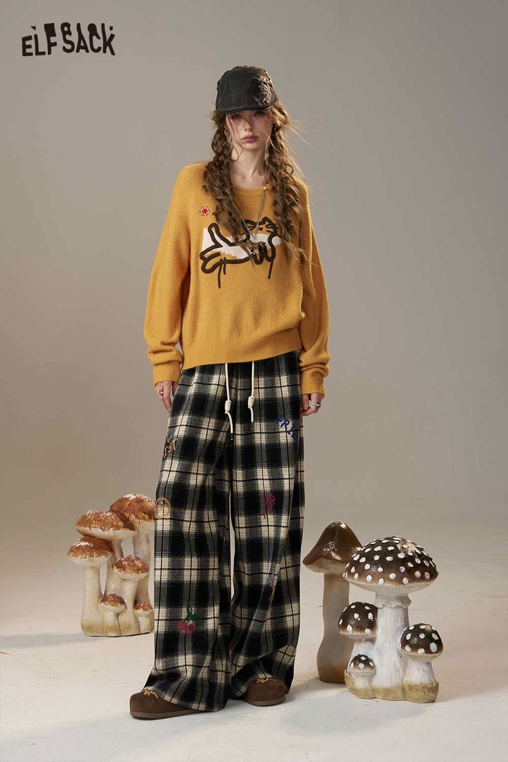 ELFSACK cartoon embroidery sweater in yellow with playful design, paired with plaid wide-leg pants