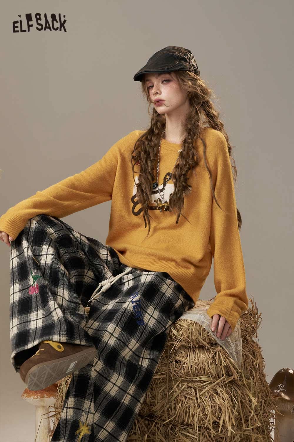 ELFSACK Cartoon Embroidery Sweater in mustard yellow, styled with plaid pants for a cozy, trendy look