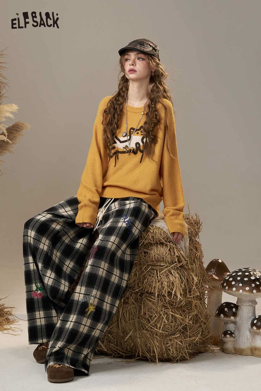 ELFSACK cartoon embroidery sweater in mustard color paired with plaid wide-leg pants for a trendy look