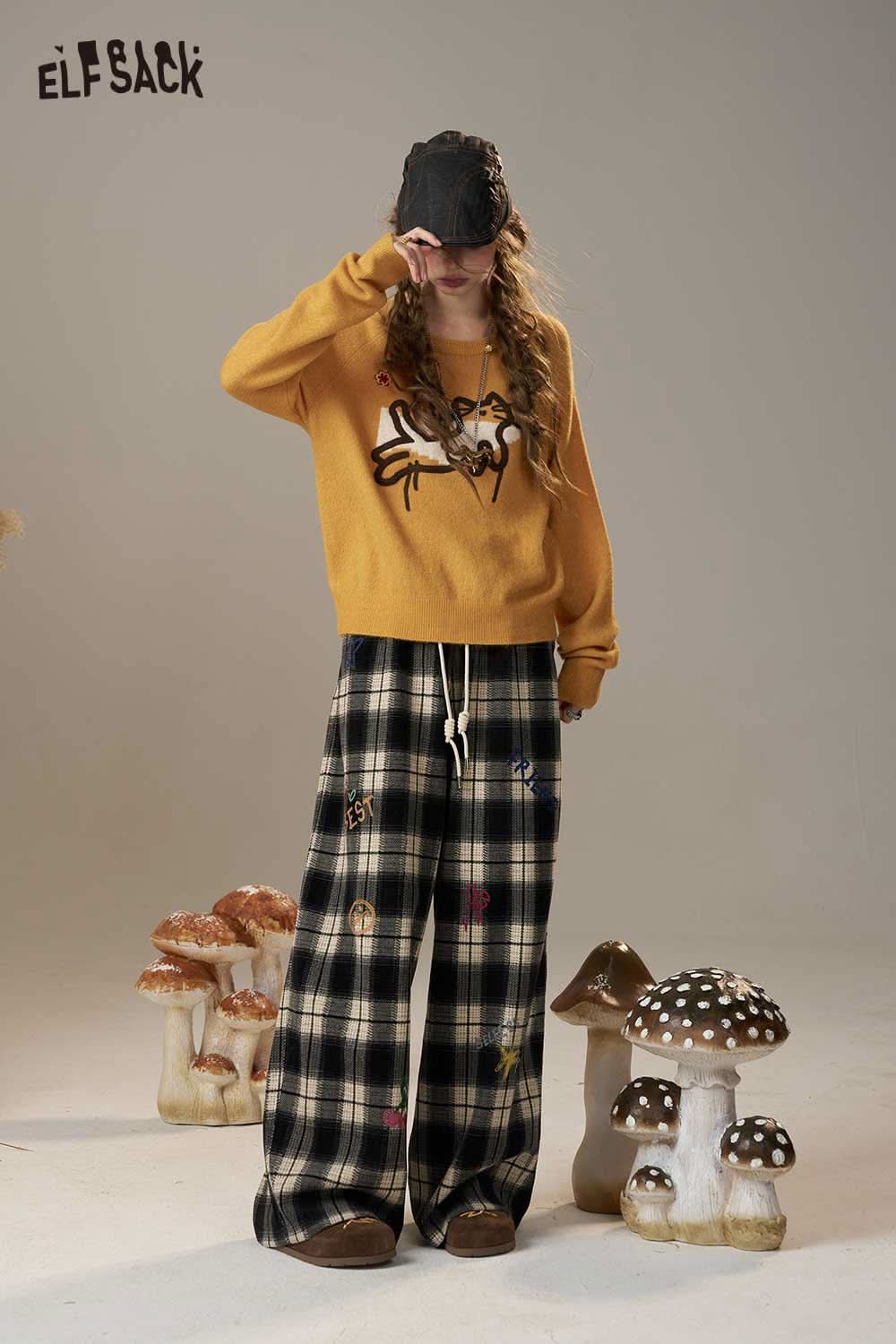 ELFSACK cartoon embroidery sweater in mustard yellow featuring playful designs and relaxed fit.