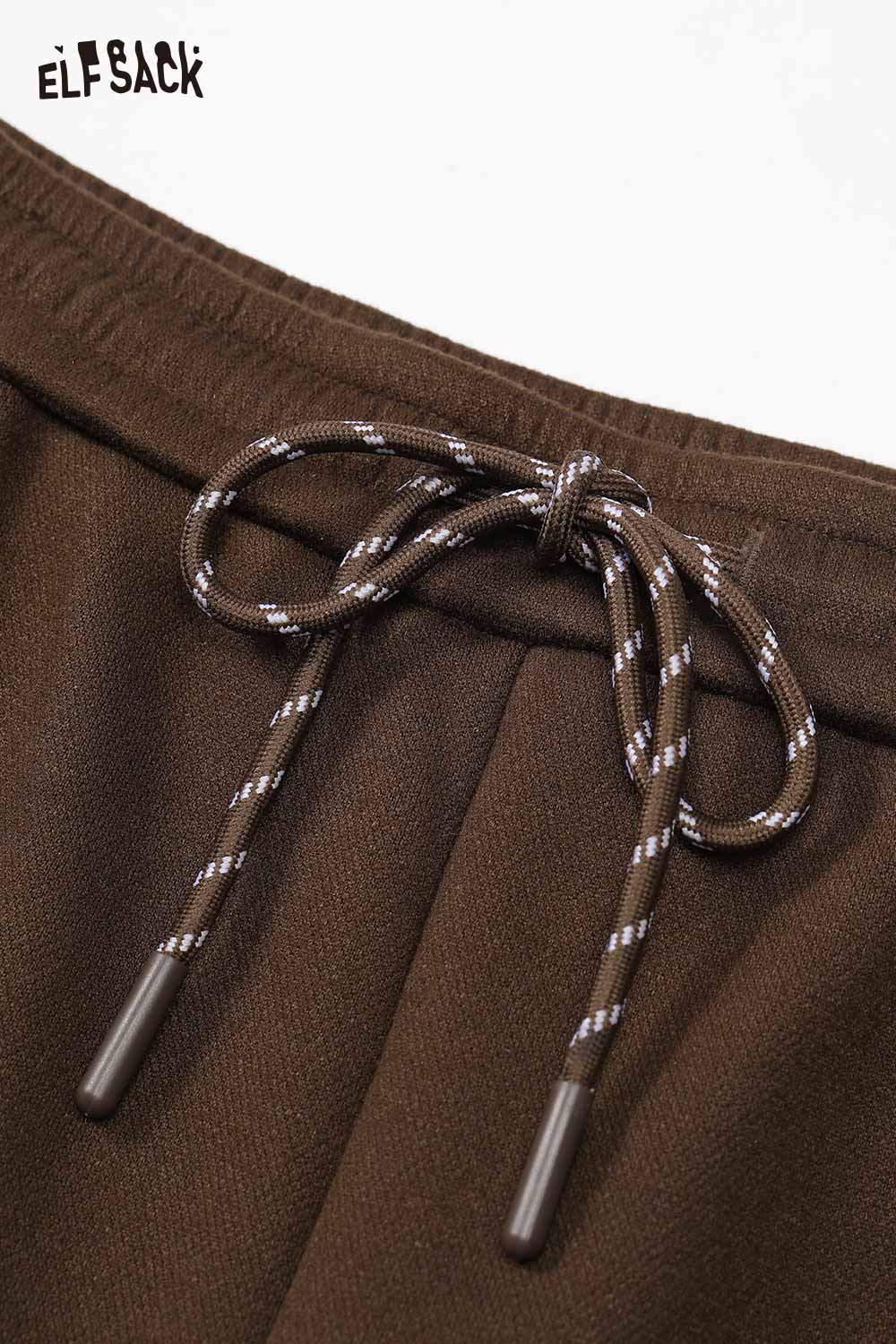 Close-up of ELFSACK brown pants featuring a drawstring, showcasing cartoon embroidery sweatpants for women