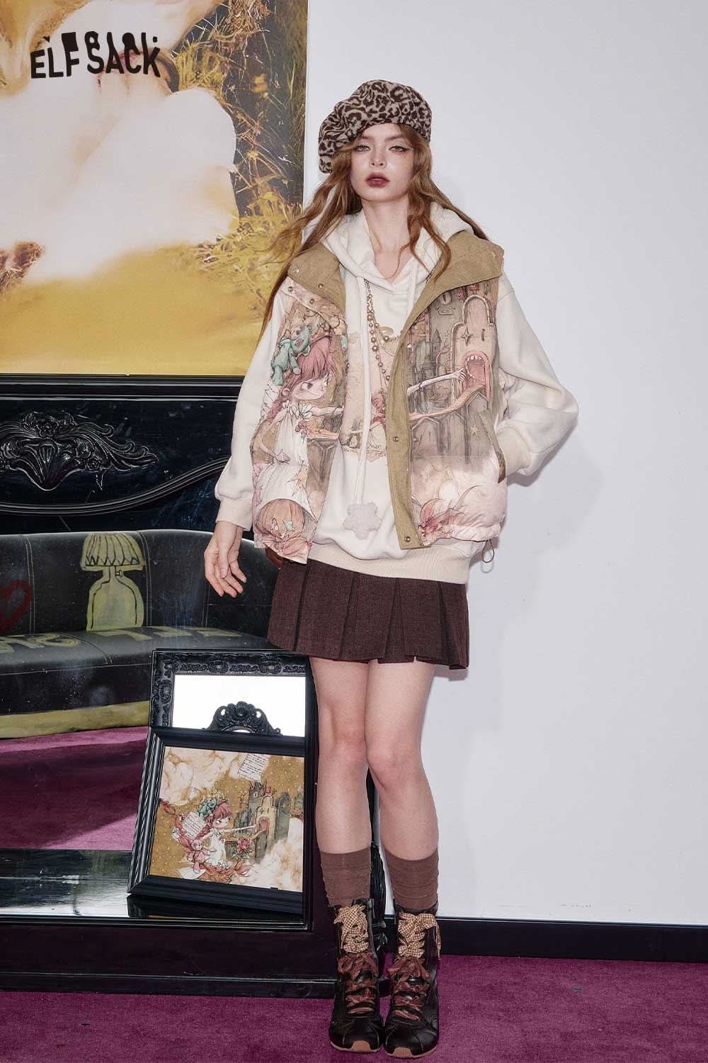 ELFSACK cartoon graphic puffer vest worn by a model with a stylish outfit in a modern setting