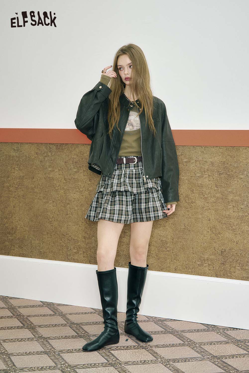 ELFSACK fitted tee featuring cartoon stitch detail, styled with a plaid skirt and jacket for a trendy look