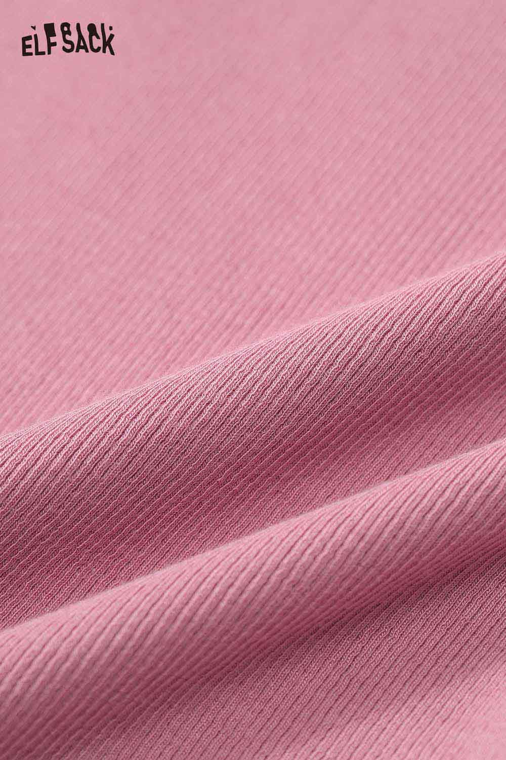 Close-up of ELFSACK pink fabric showing texture of cartoon stitch detail fitted tee