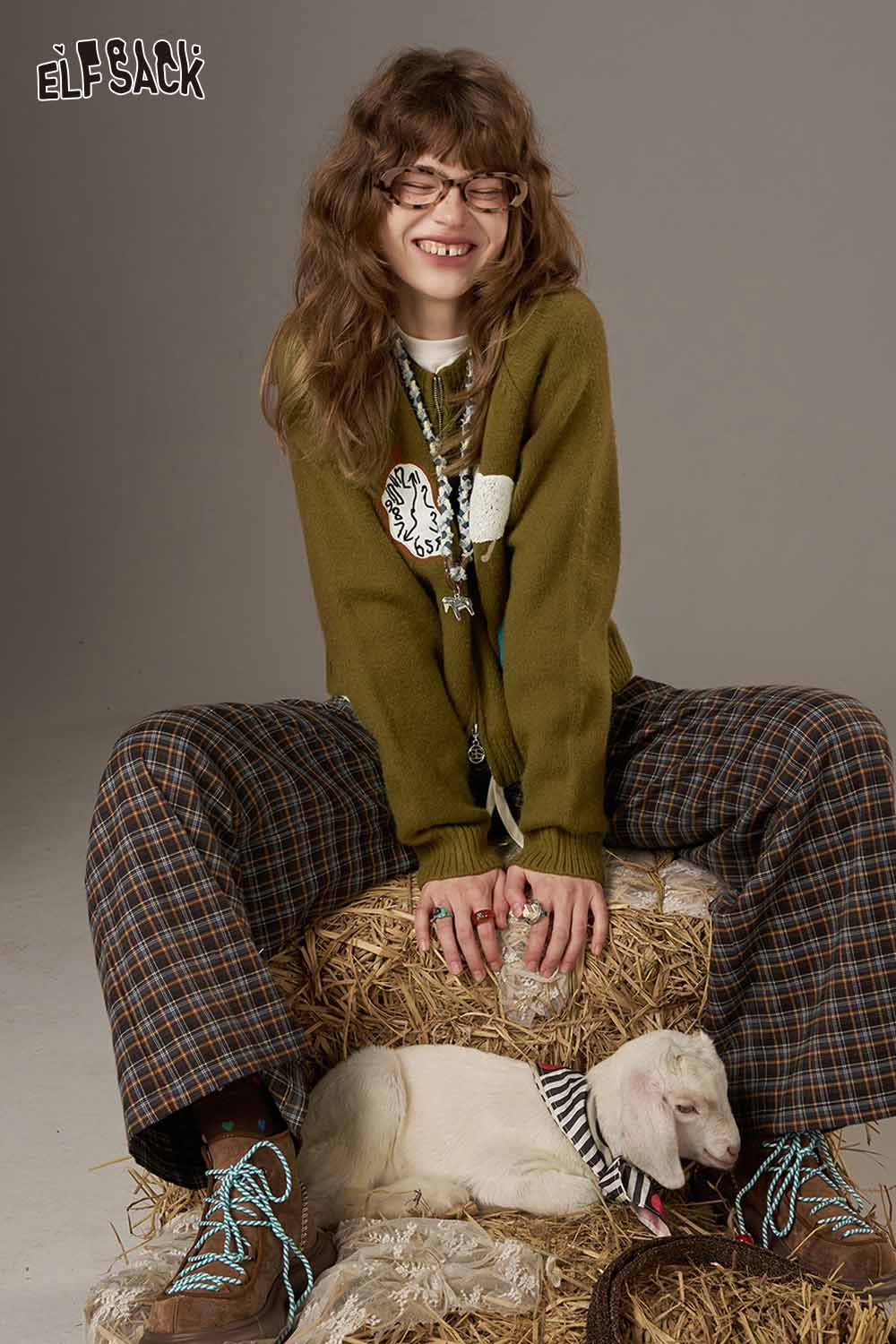 ELFSACK cartoon sweater cardigan for women in green worn with plaid pants, featuring a playful design and cozy fit
