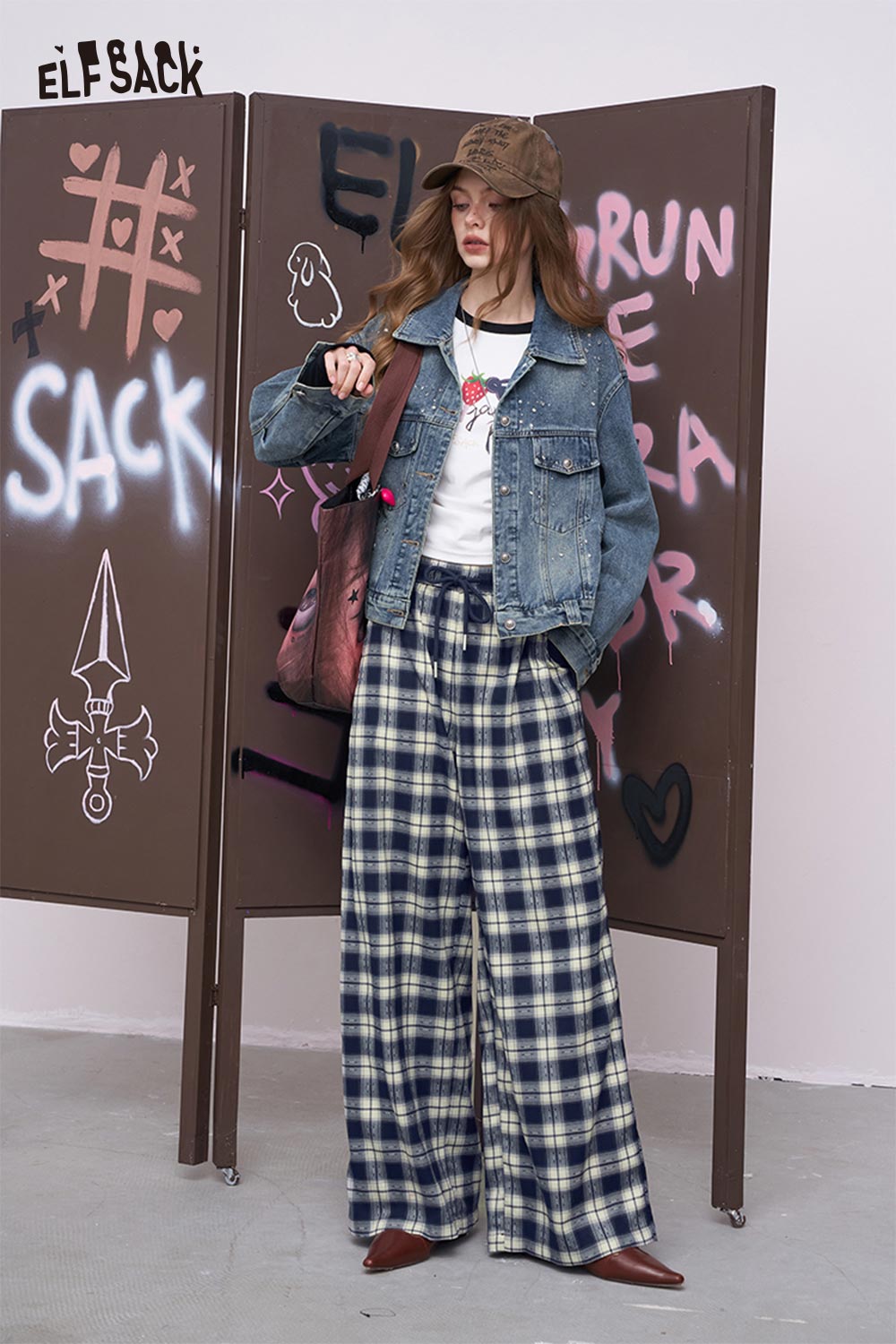 ELFSACK model wearing women's plaid wide leg pants with denim jacket white tee brown cap and shoulder bag