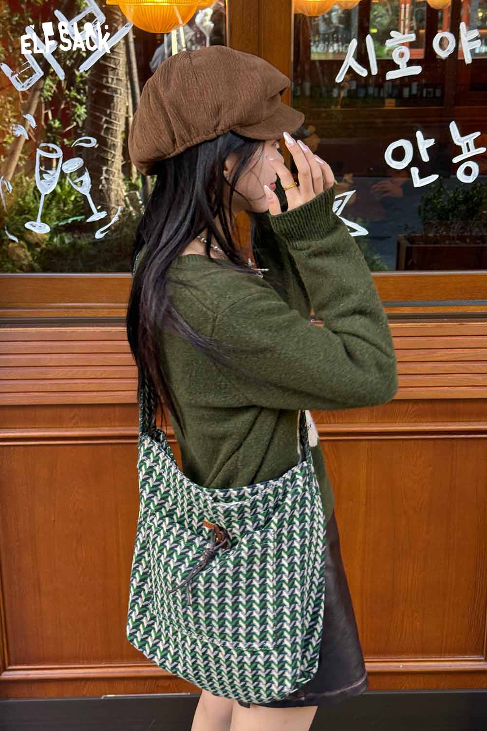 Stylish ELFSACK casual striped crossbody bag worn by a woman in a cozy sweater and cap