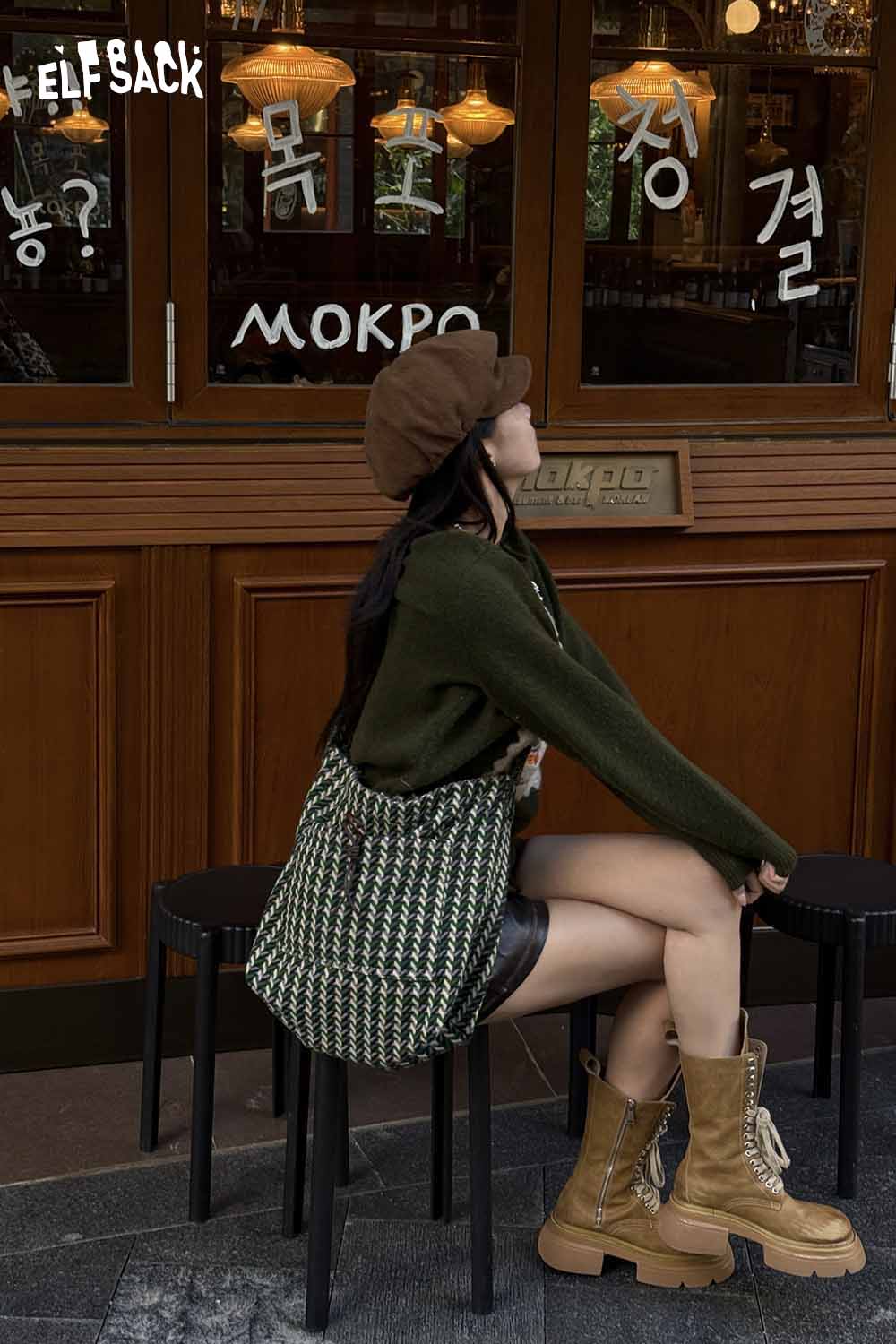 ELFSACK casual striped crossbody bag styled with a green sweater and brown hat for a trendy look