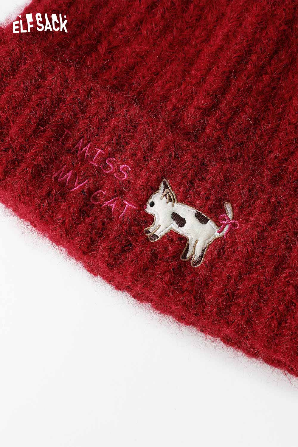 
                  
                    ELFSACK Cat Ear Beanie for women in red with playful dog embroidery and unique lettering
                  
                