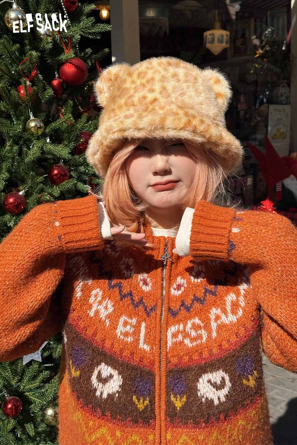 ELFSACK cat ear leopard plush hat styled with a cozy orange sweater against a festive backdrop