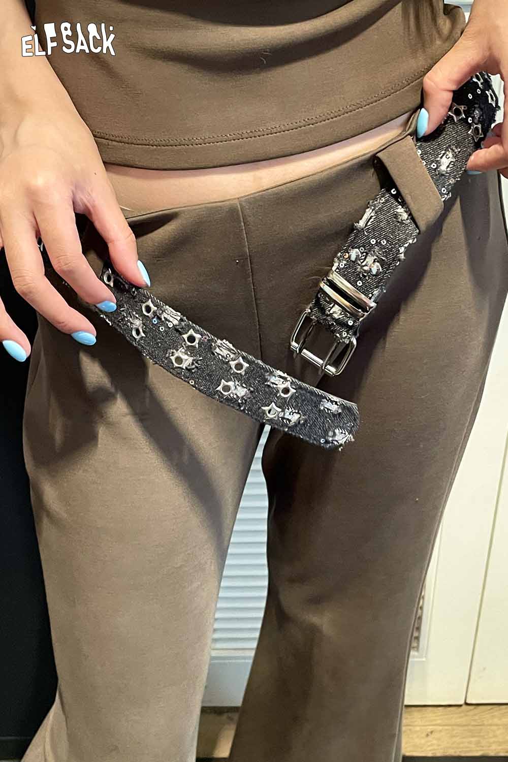 ELFSACK celestial motif leather belt for women styled with brown outfit for a trendy look