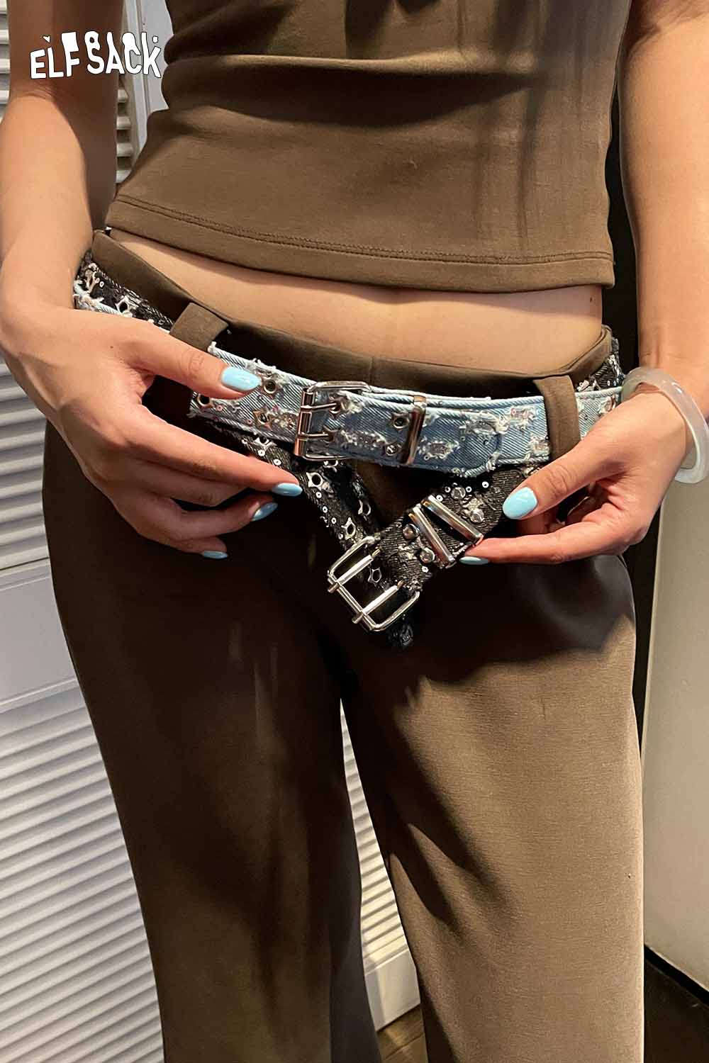 ELFSACK celestial motif leather belt for women styled with a casual outfit and denim details