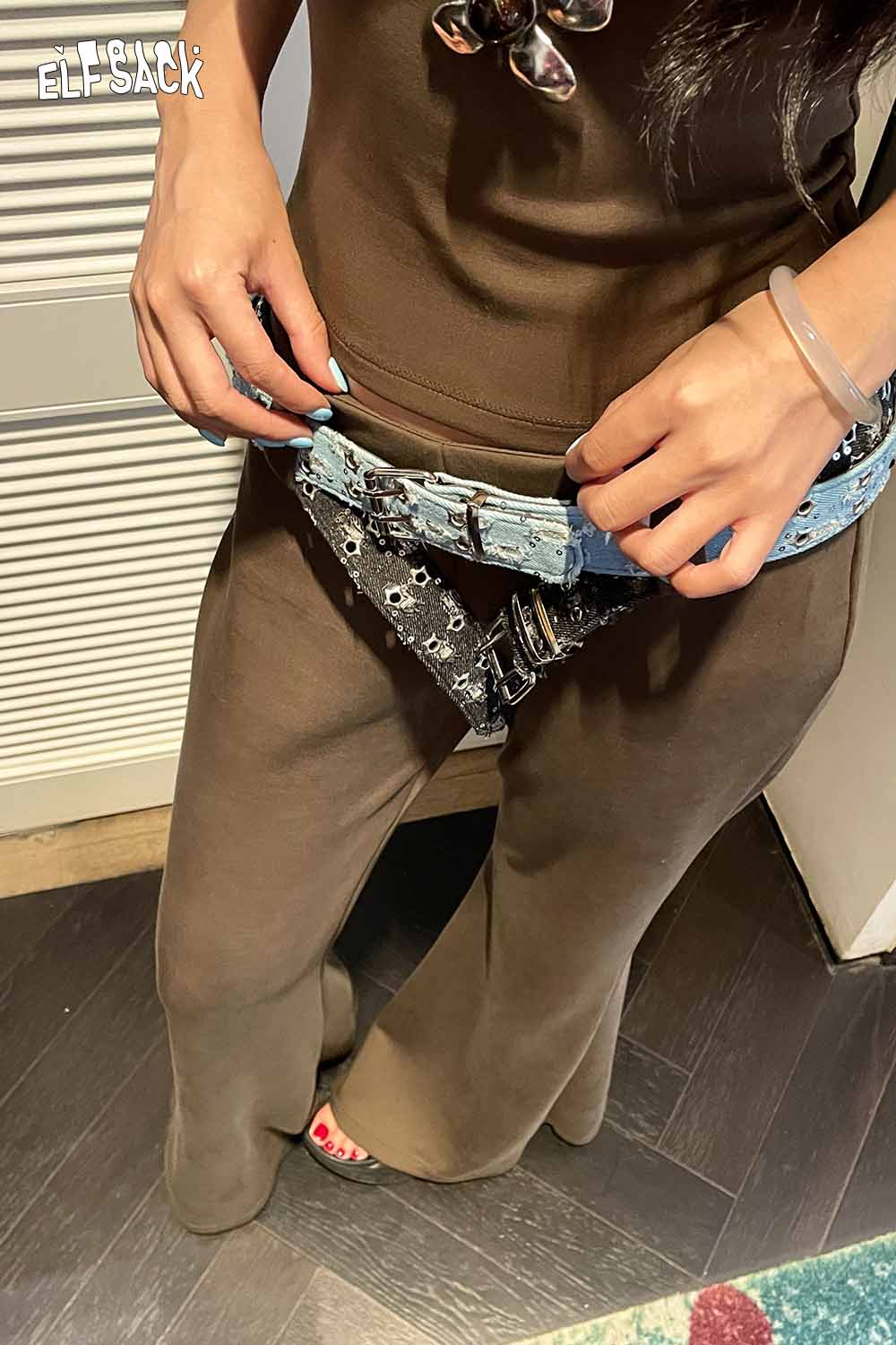 ELFSACK celestial motif leather belt for women styled with a brown outfit and unique details