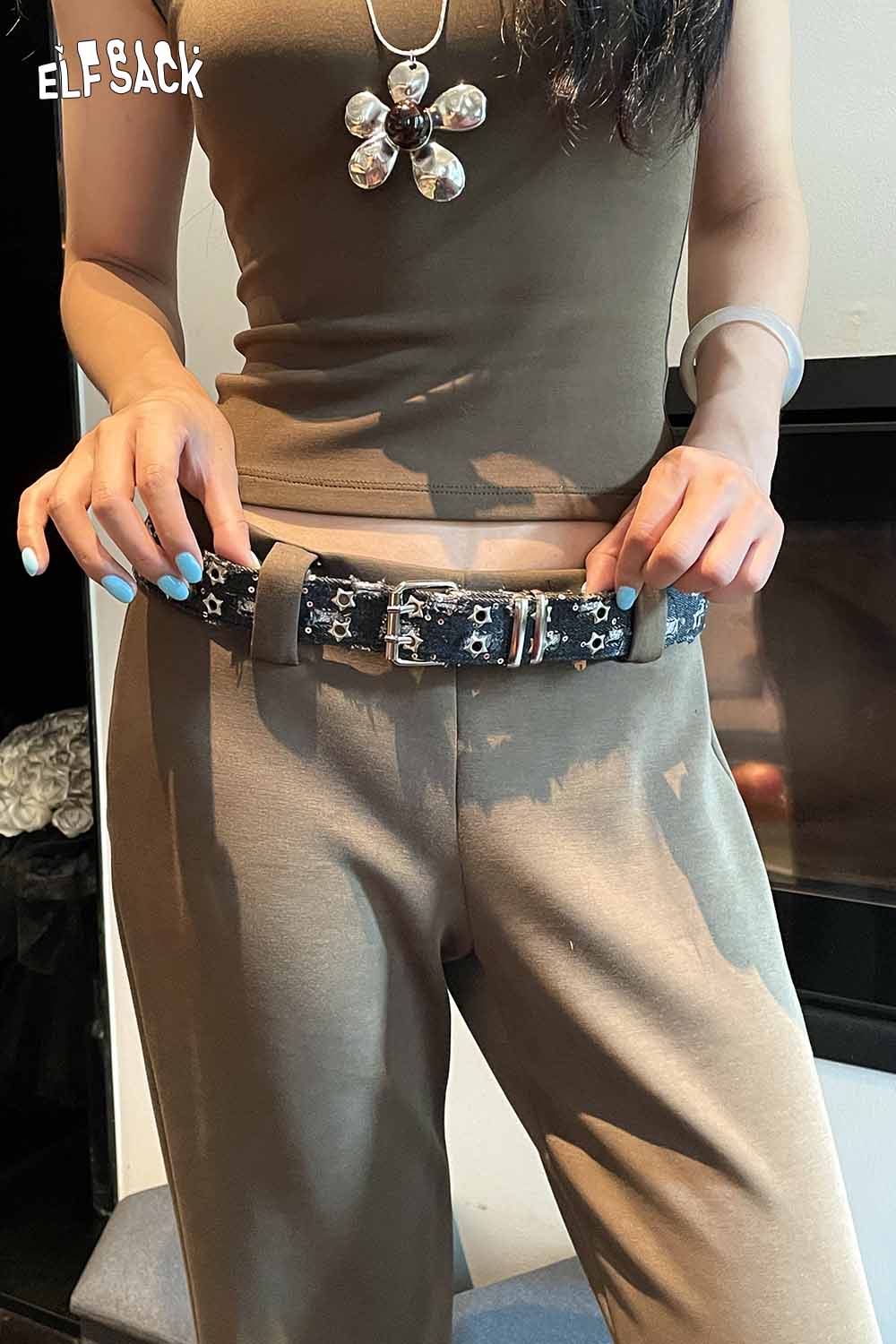 ELFSACK celestial motif leather belt for women styled with a casual outfit in neutral tones