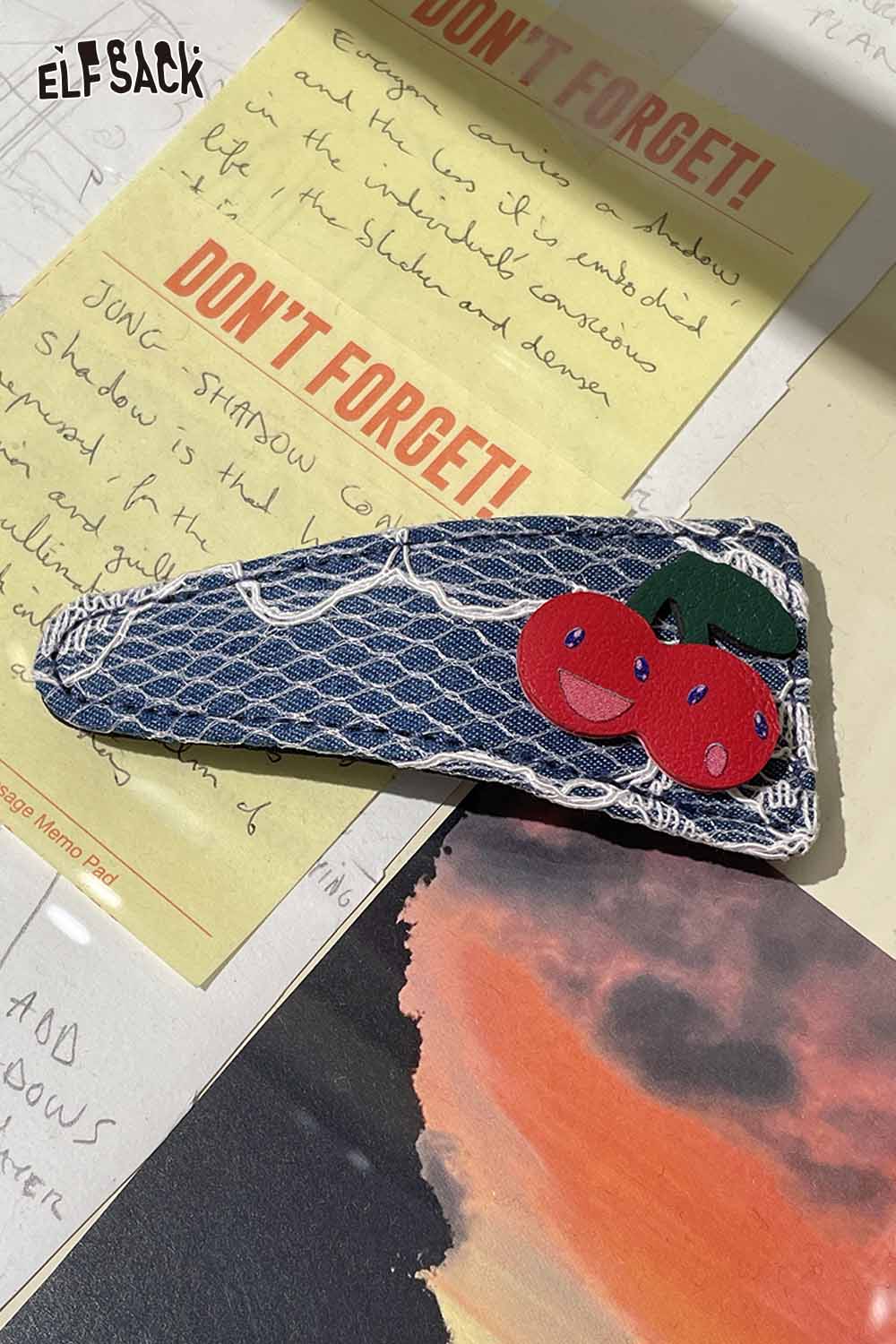 ELFSACK cherry motif hair clip with denim background and bright cherry appliqués for stylish hair accessory