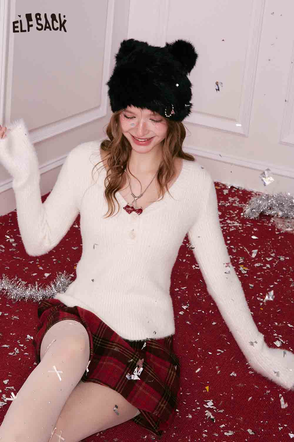 ELFSACK cherry pendant heart necklace worn with a cozy sweater and plaid skirt against a festive background