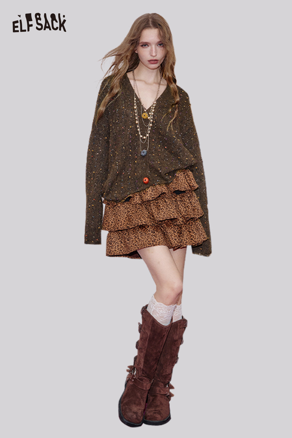 ELFSACK chunky v-neck cardigan for women paired with a stylish layered skirt and knee-high boots