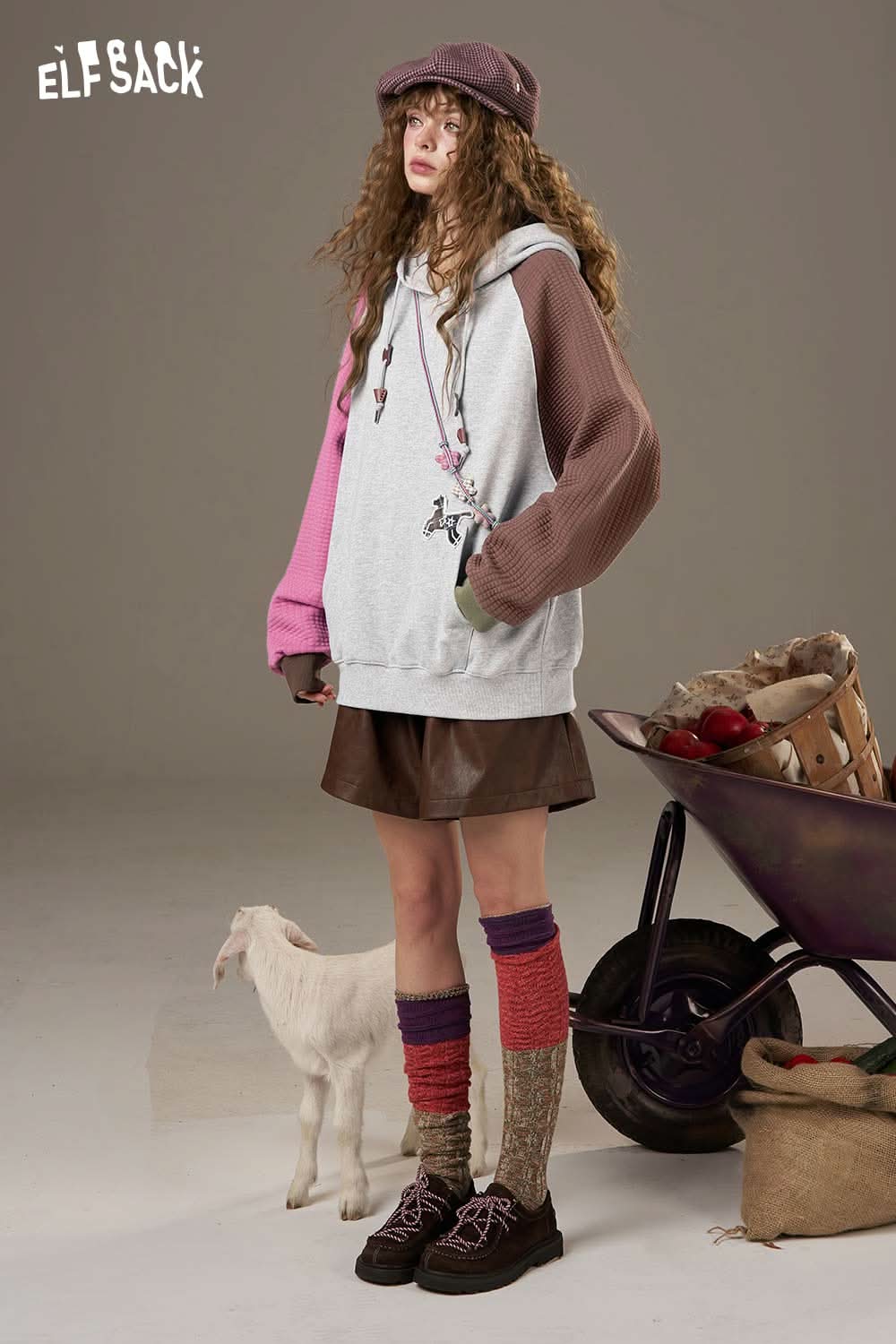 ELFSACK colorblock raglan sleeve sweatshirt styled with a brown skirt and colorful knee-high socks