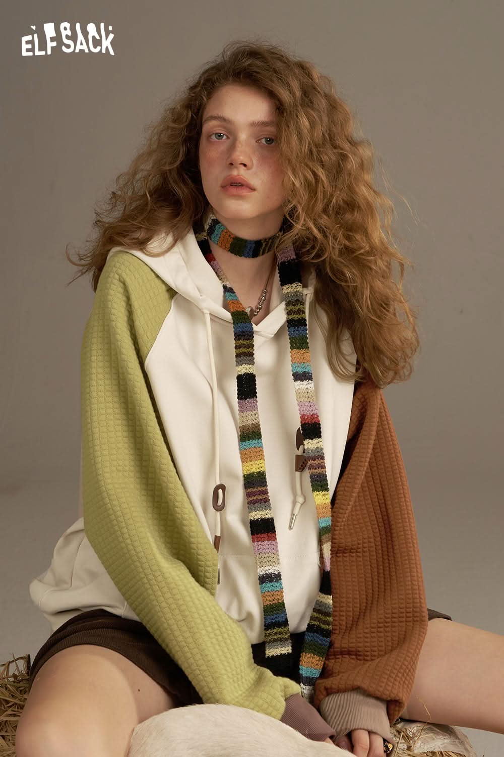 ELFSACK colorblock raglan sleeve sweatshirt featuring a two-tone design with a cozy hood