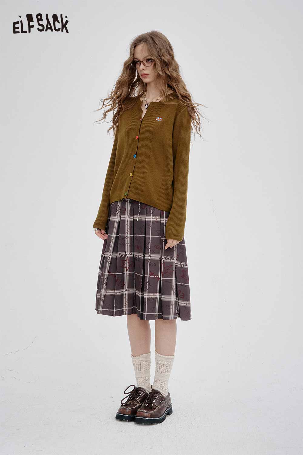 Model wearing a colorful button knit sweater with a brown plaid skirt for a stylish autumn look