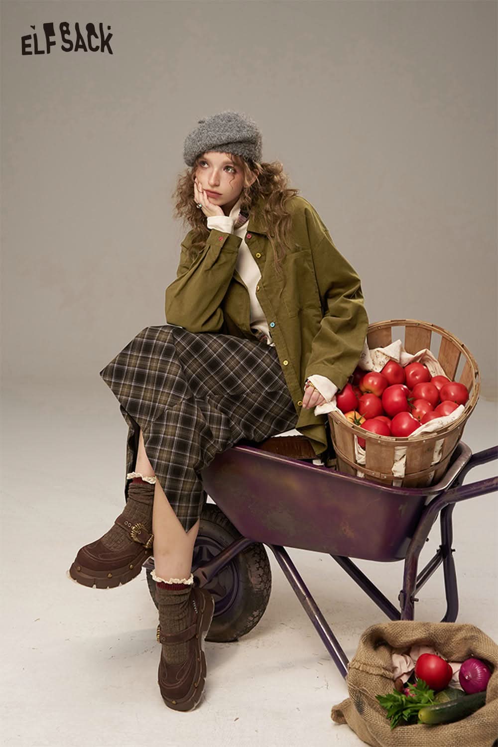 Model wearing a colorful button pocket shirt for women, paired with a plaid skirt and a gray beret