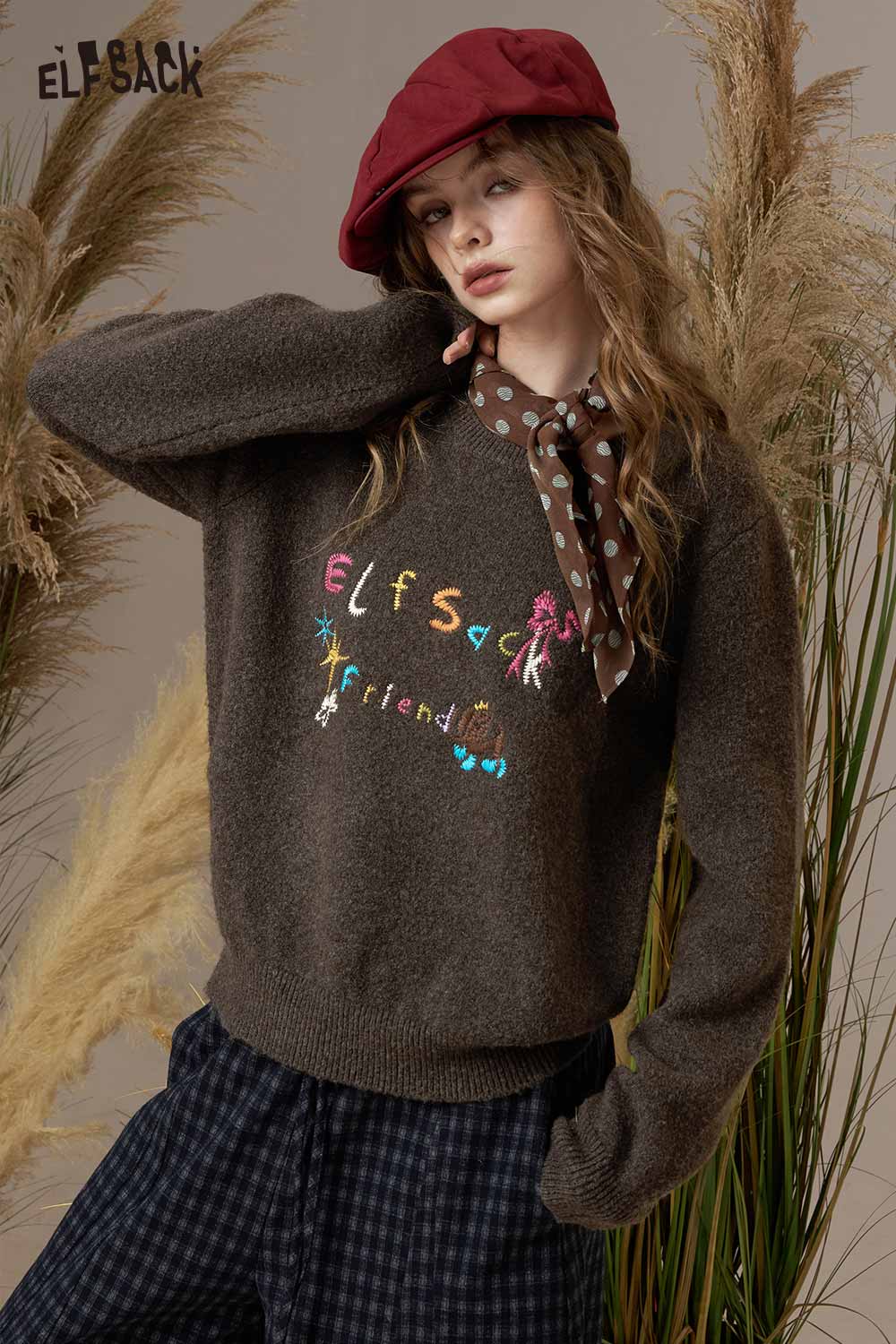 Model wearing an ELFSACK colorful logo embroidery sweater with playful designs and cozy style