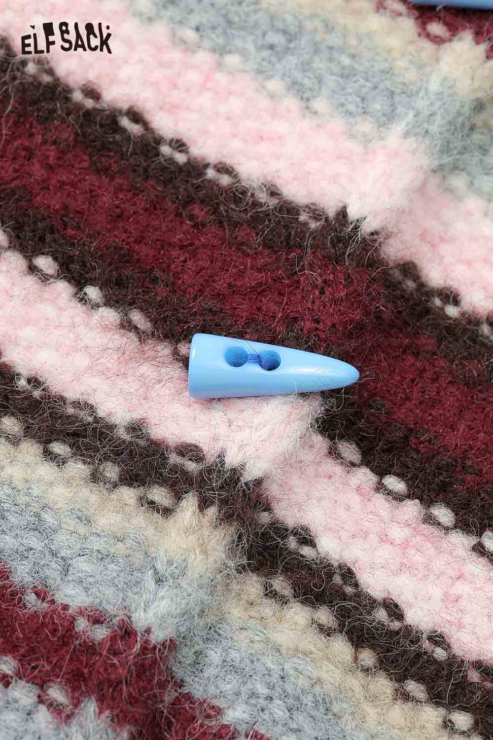 Close-up of an ELFSACK colorful striped hooded sweater women with a unique blue button detail