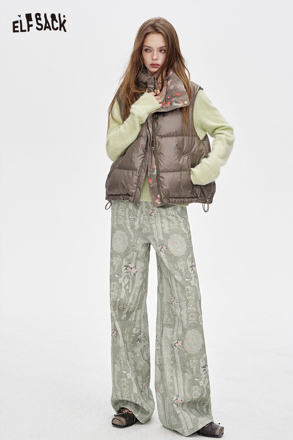 ELFSACK cotton allover print jeans for women styled with a puffer vest and cozy sweater