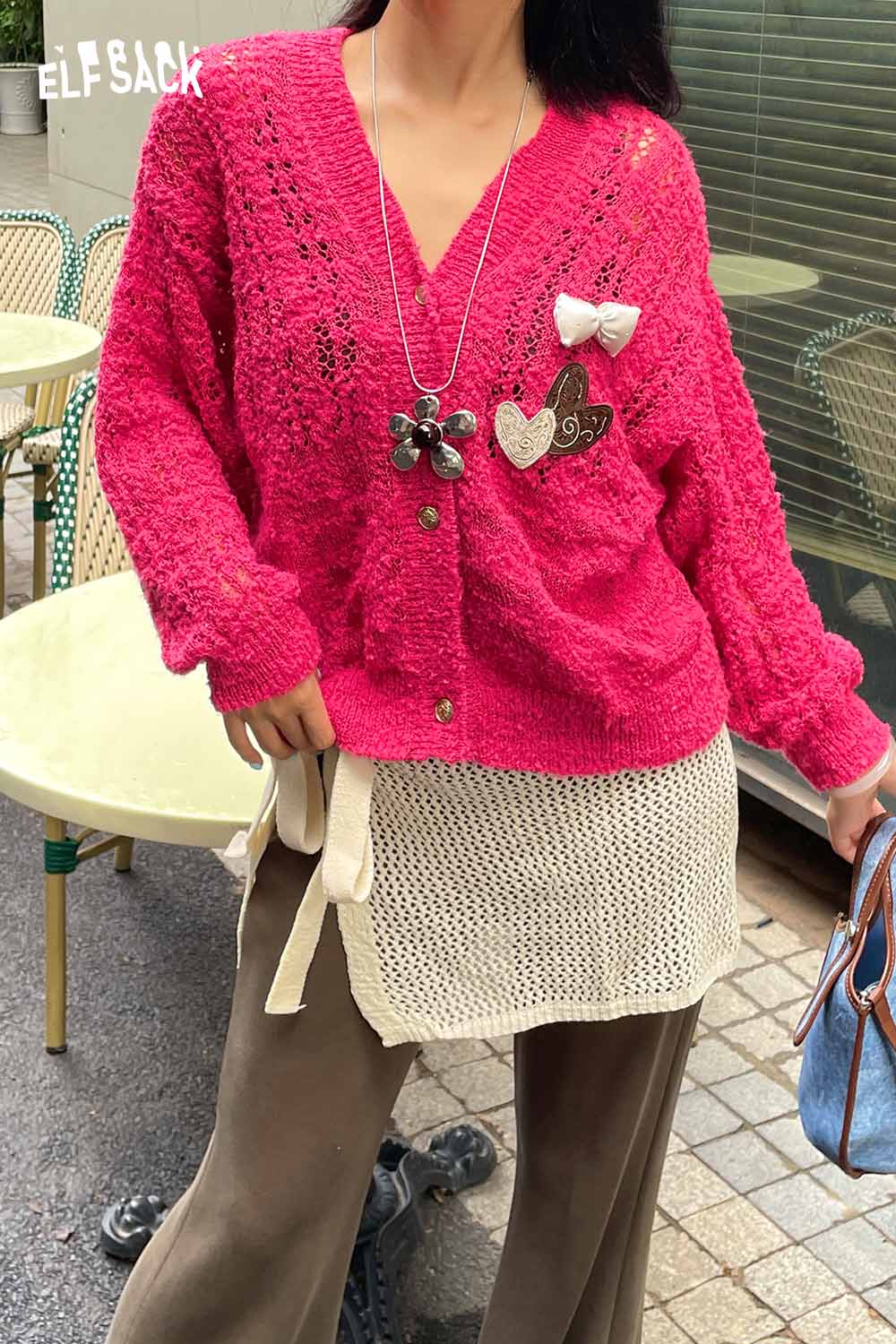 ELFSACK vibrant pink cardigan layered over a cotton blend knit skirt with apron for a trendy outfit