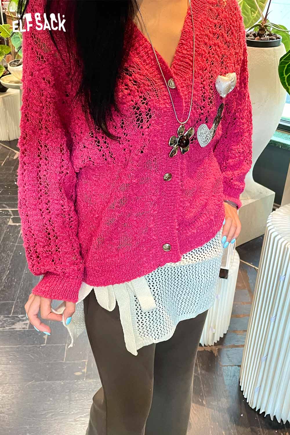 Pink ELFSACK cotton blend knit skirt with apron layered over a stylish outfit