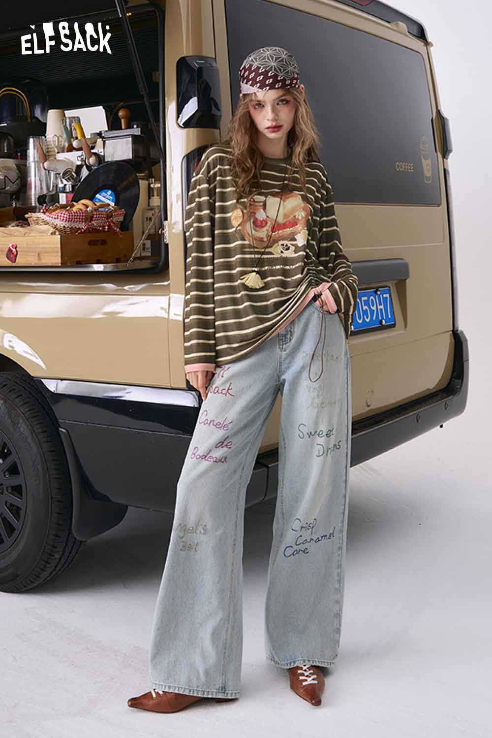 Model wearing ELFSACK relaxed fit ruched stripe t-shirt in green with long sleeves paired with embroidered wide leg jeans