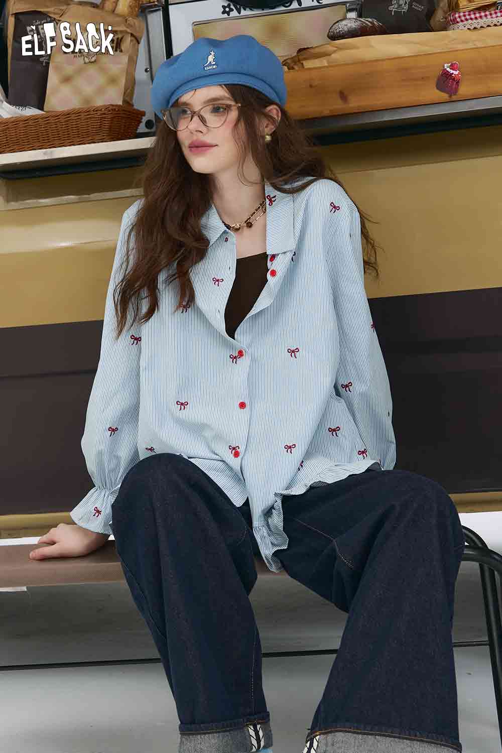 ELFSACK model wearing bow embroidered striped shirt for women light blue button down with small red bows and wide collar