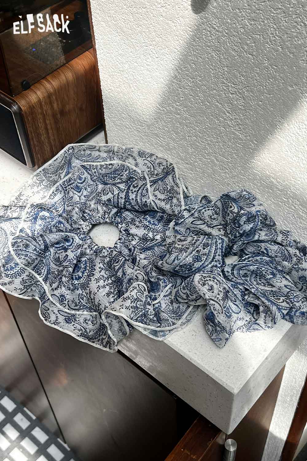 ELFSACK bohemian paisley hair tie chiffon scrunchie set in blue and white paisley on sunlit ledge