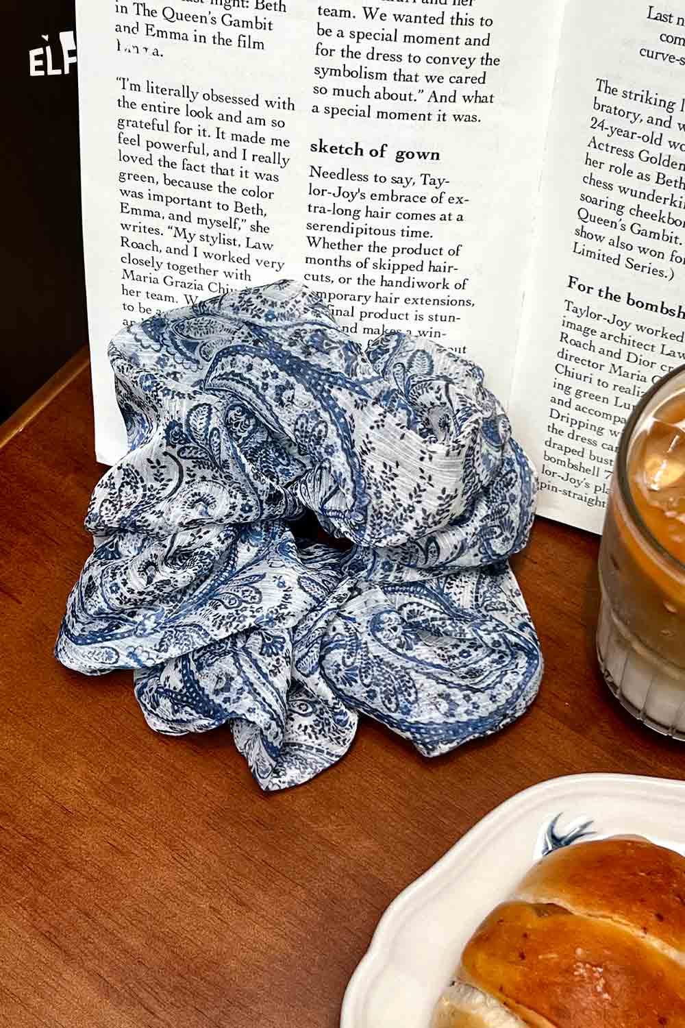 ELFSACK blue and white bohemian paisley hair tie scrunchie on wooden table with coffee and pastry