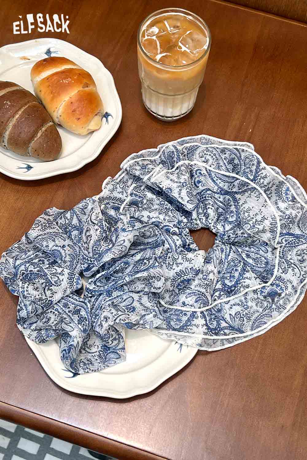 ELFSACK bohemian paisley hair tie blue and white paisley scrunchie on plate with coffee and bread
