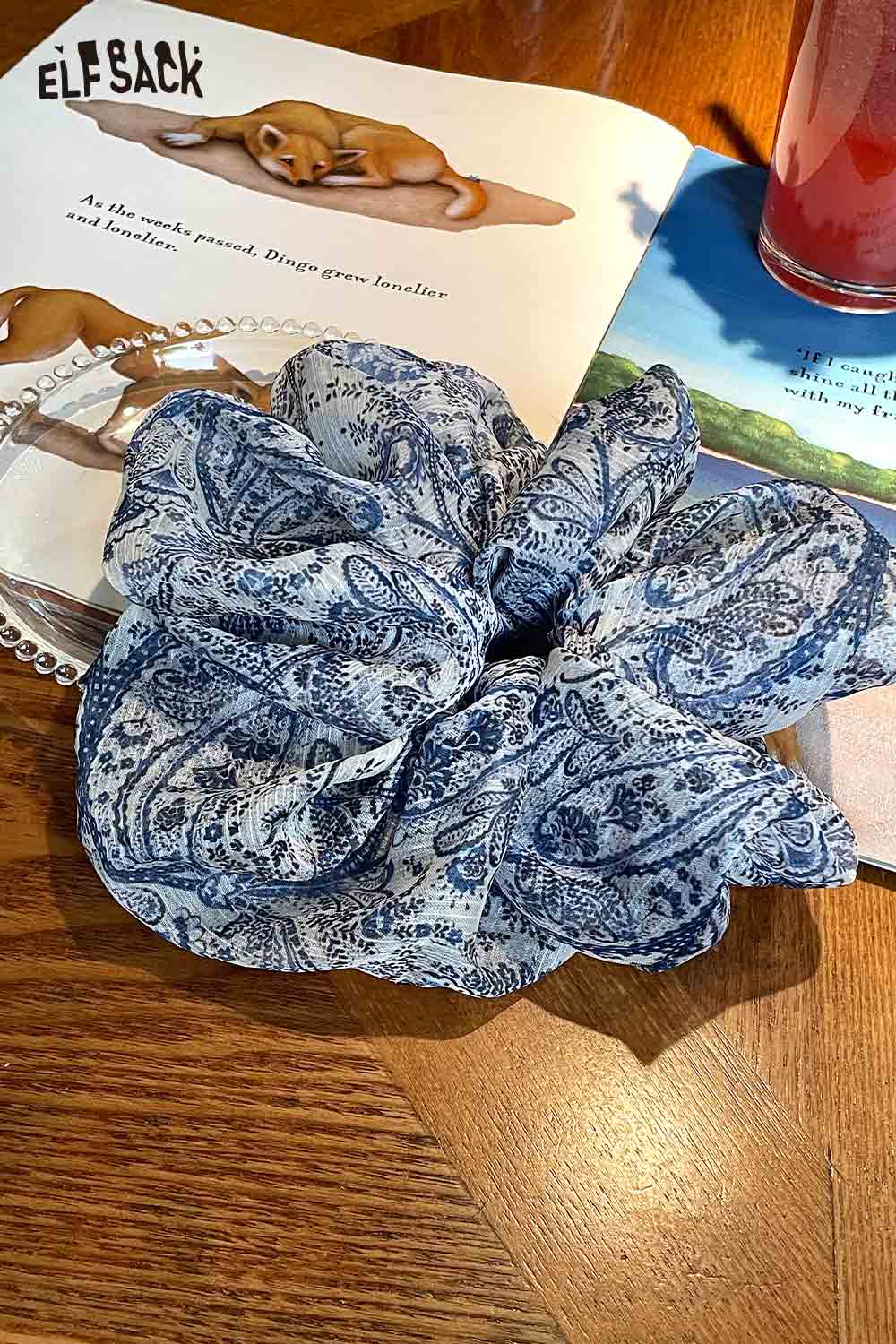 ELFSACK blue paisley scrunchie on table with book and drink bohemian paisley hair tie