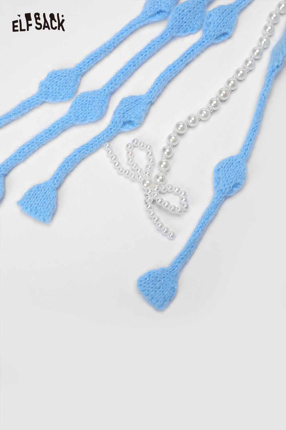 Light blue crocheted tassel ear-flap hat with decorative pearl details for stylish warmth