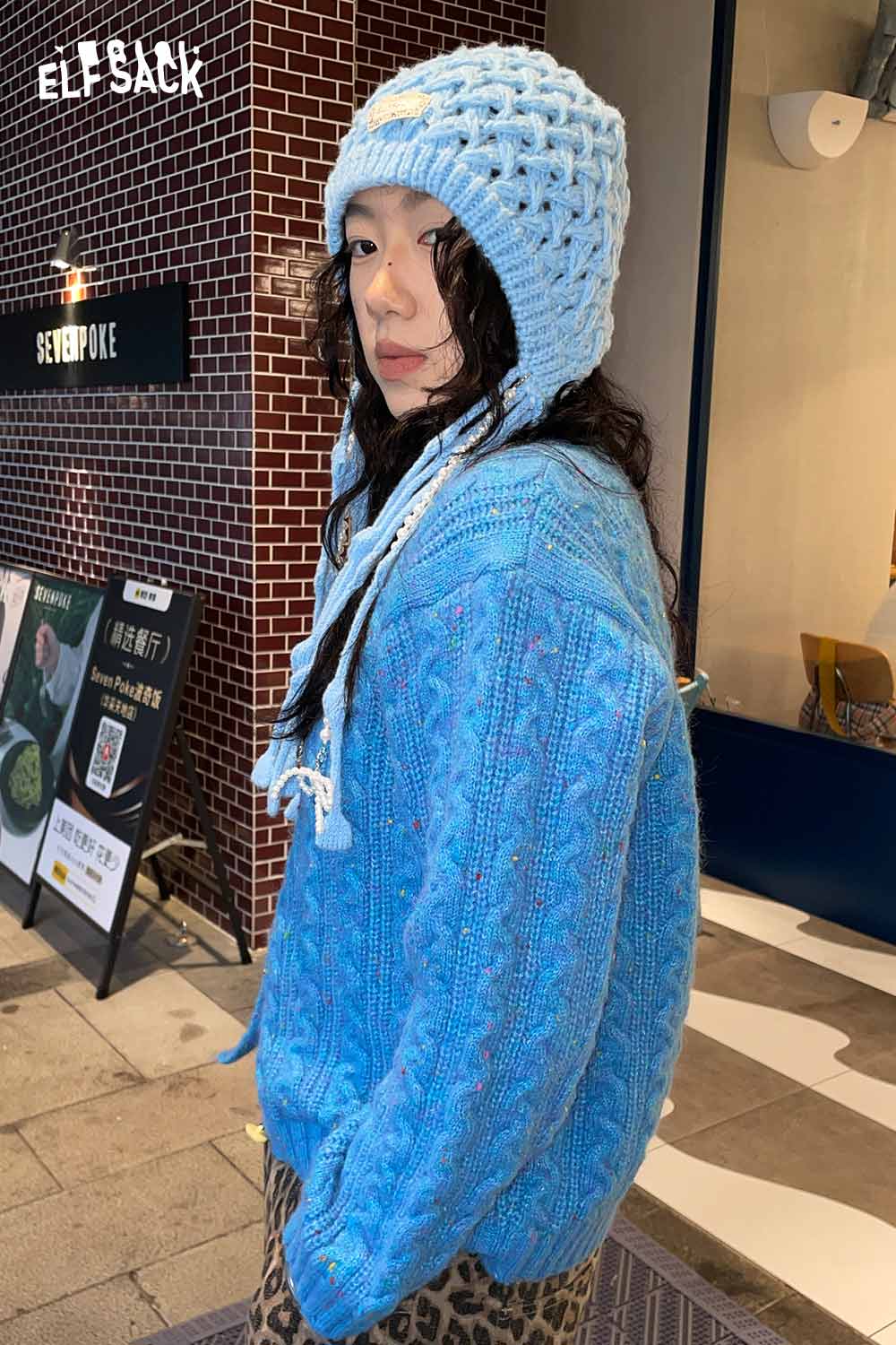 ELFSACK crocheted tassel ear-flap hat in light blue with playful design for winter style
