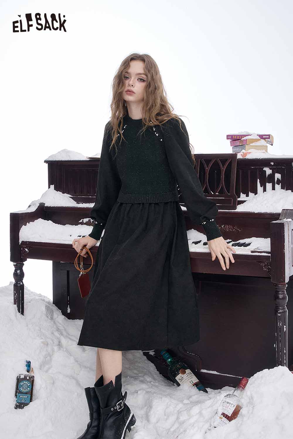 Model wearing an ELFSACK crystal accent midi dress styled with a vintage piano backdrop