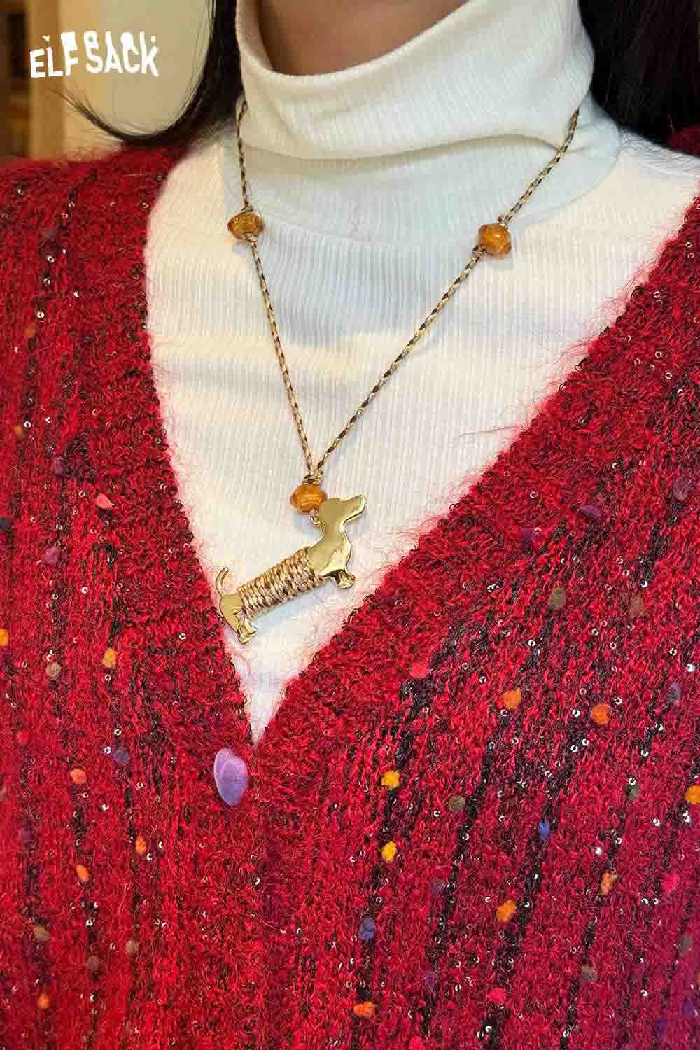 Cute dog pendant necklace worn with a red knitted sweater and white turtleneck for a stylish look