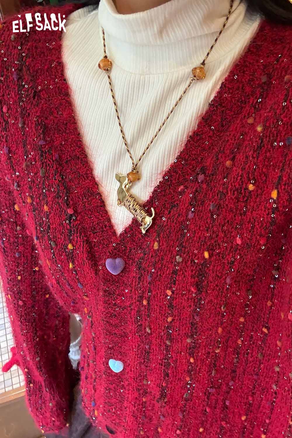 ELFSACK cute dog pendant necklace worn with a red textured cardigan and white turtleneck top