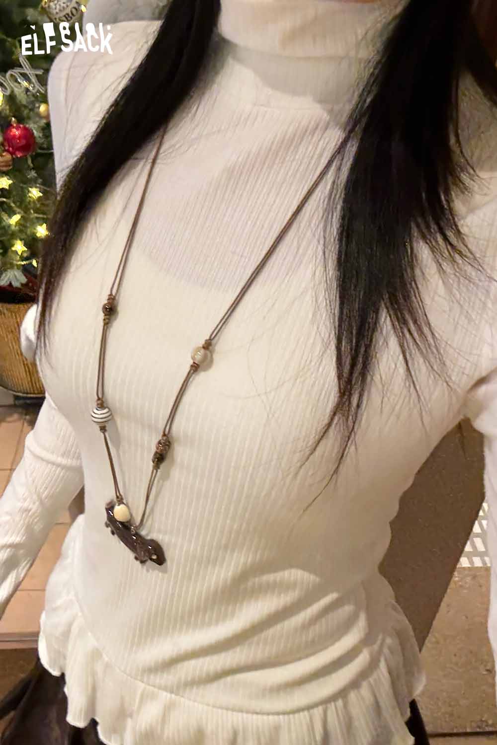 ELFSACK cute dog pendant necklace worn with a stylish white ribbed turtleneck top