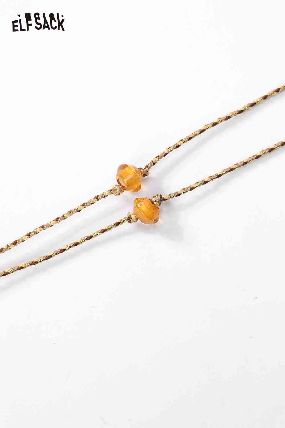 ELFSACK Cute dog pendant necklace with a braided strap and decorative beads for a playful look