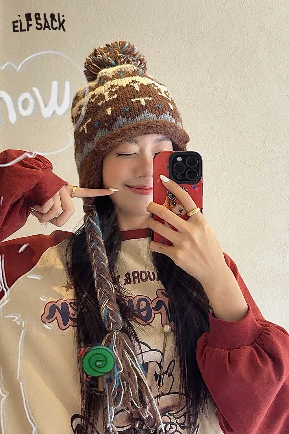 Stylish model wearing a cute Fair Isle knit beanie in brown with colorful patterns