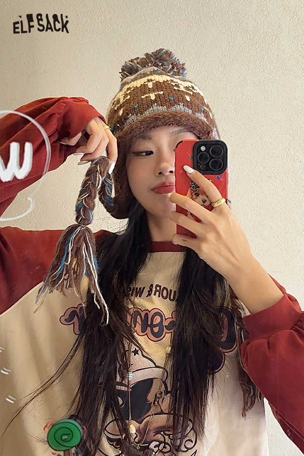 Stylish model wearing a cute Fair Isle knit beanie with a pompom on top