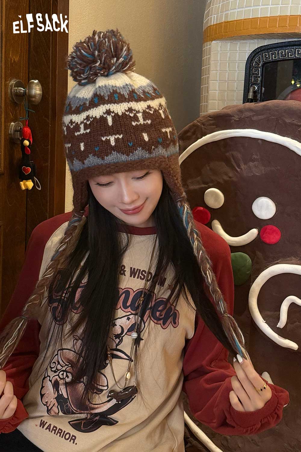 Cute Fair Isle knit beanie in brown tones with pom pom, styled with a cozy outfit