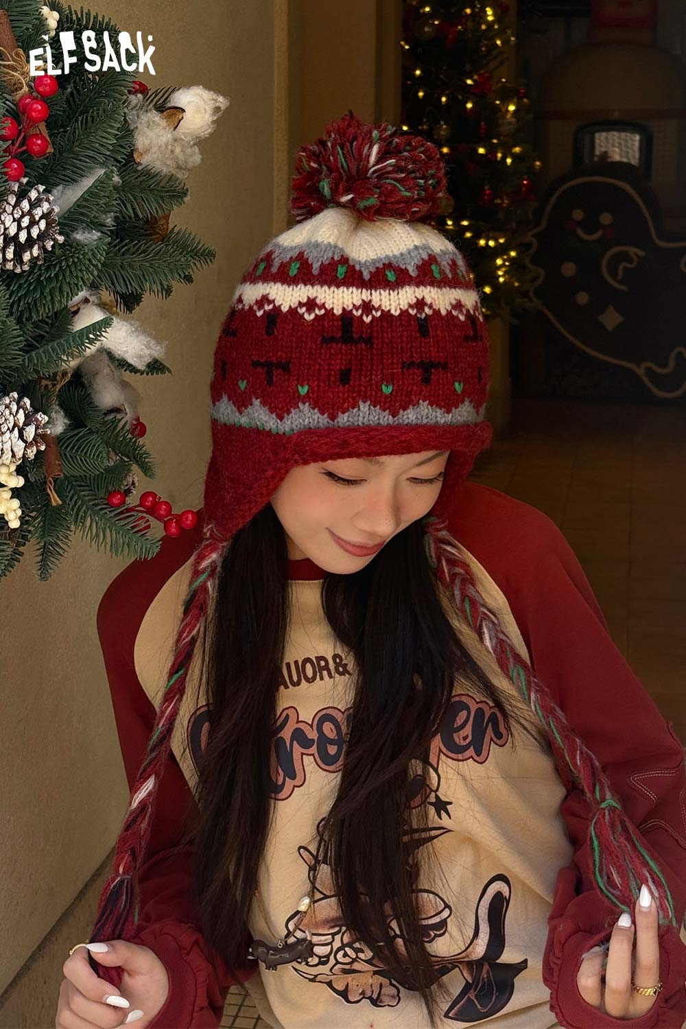 Woman wearing a cute Fair Isle knit beanie with a festive design and pompom on top
