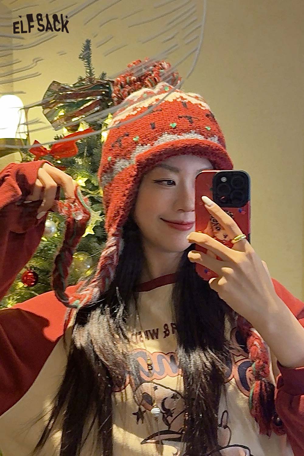 Cute Fair Isle knit beanie in red with multi-color patterns and pom pom on top, styled for winter wear