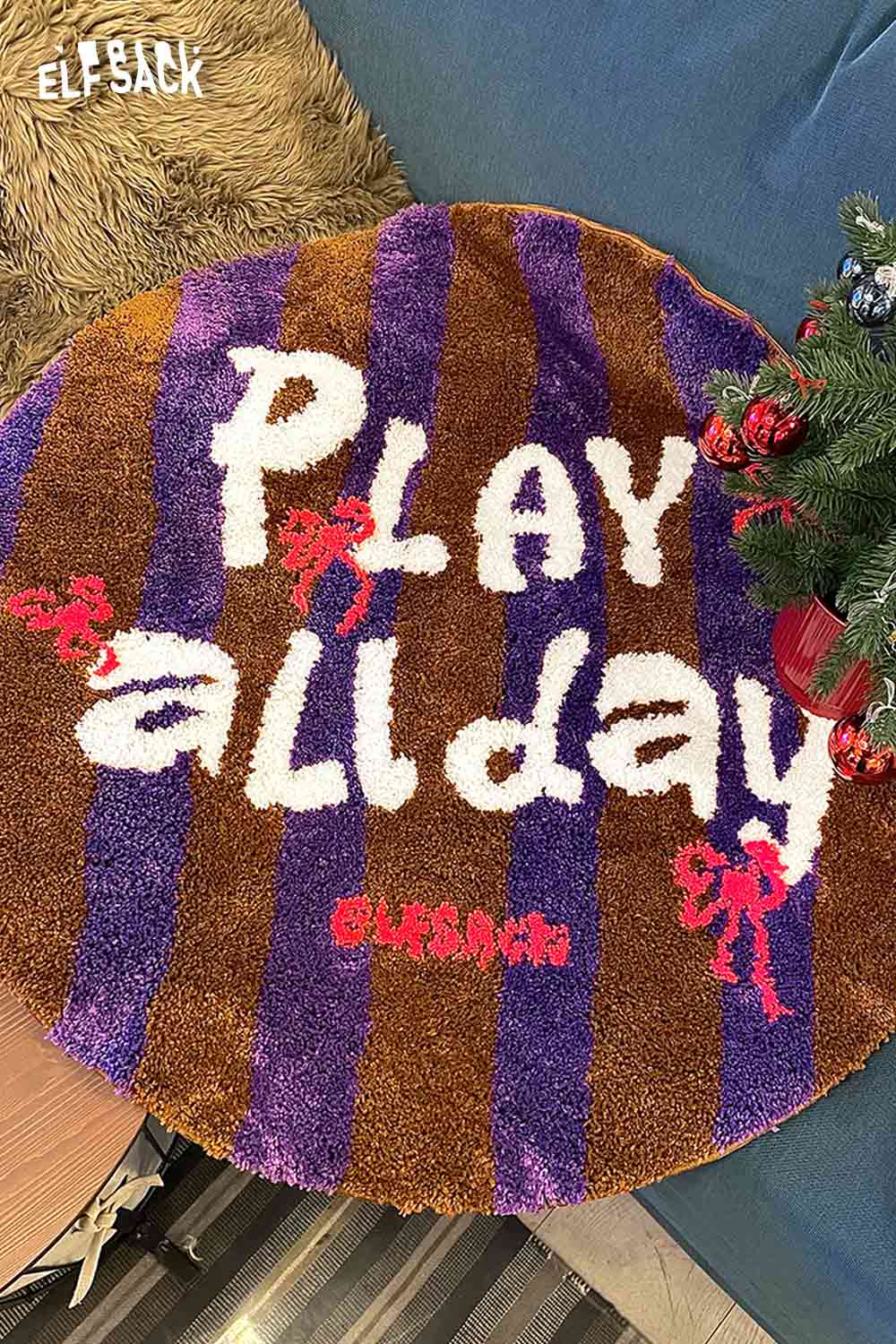 Cute round striped rug with playful 'Play all day' design in vibrant colors by ELFSACK